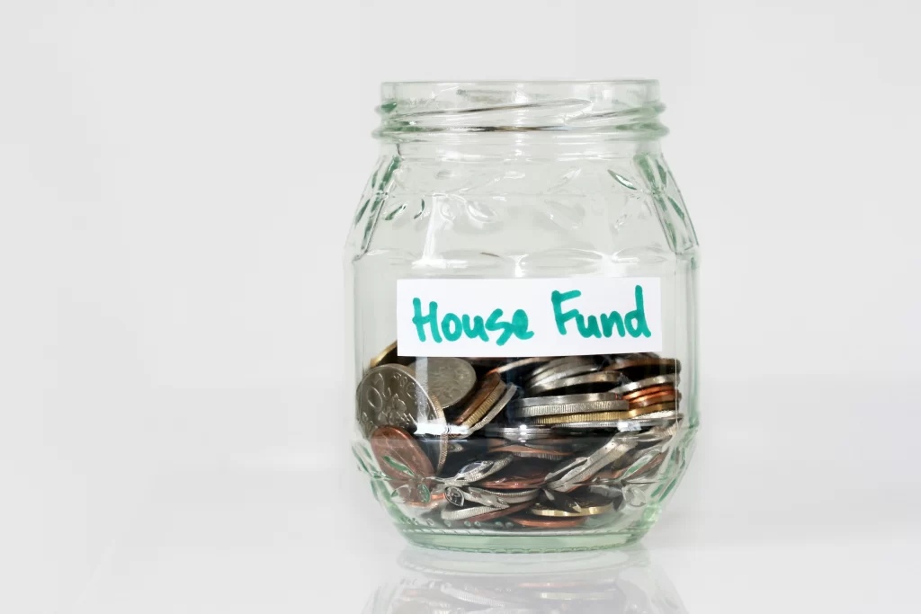 A savings jar named 'house fund'