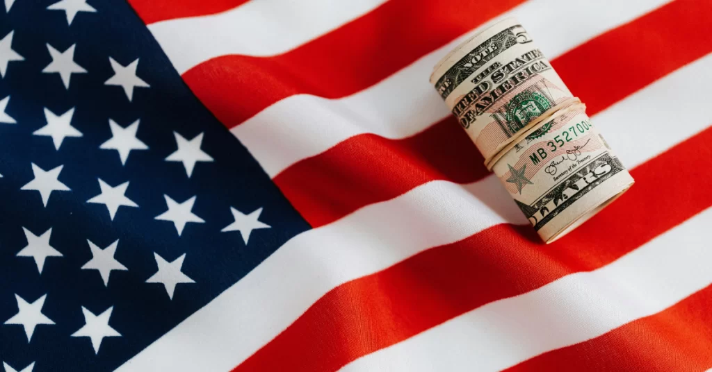 A picture of the american flag with money over it