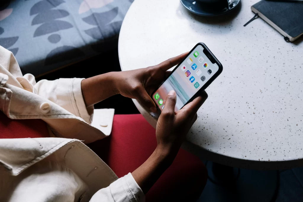 A close-up of a woman on her iphone with Instagram and Facebook apps