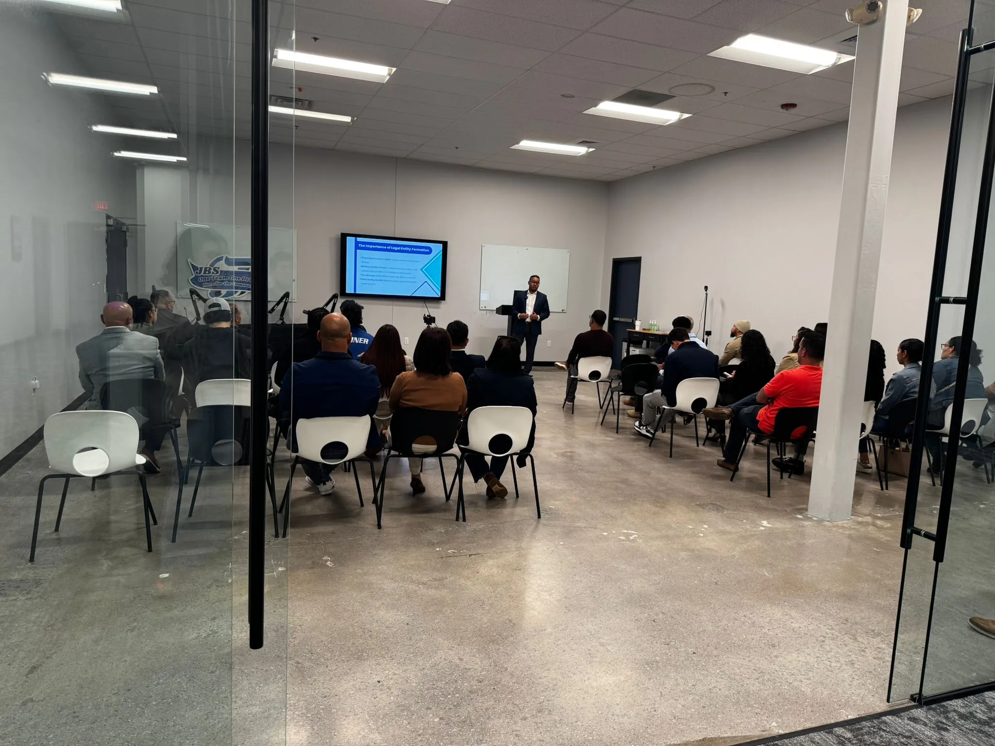 a picture of jbs ceo, rob aquino, speaking to a room of entrepreneurs in the jbs event space in methuen ma