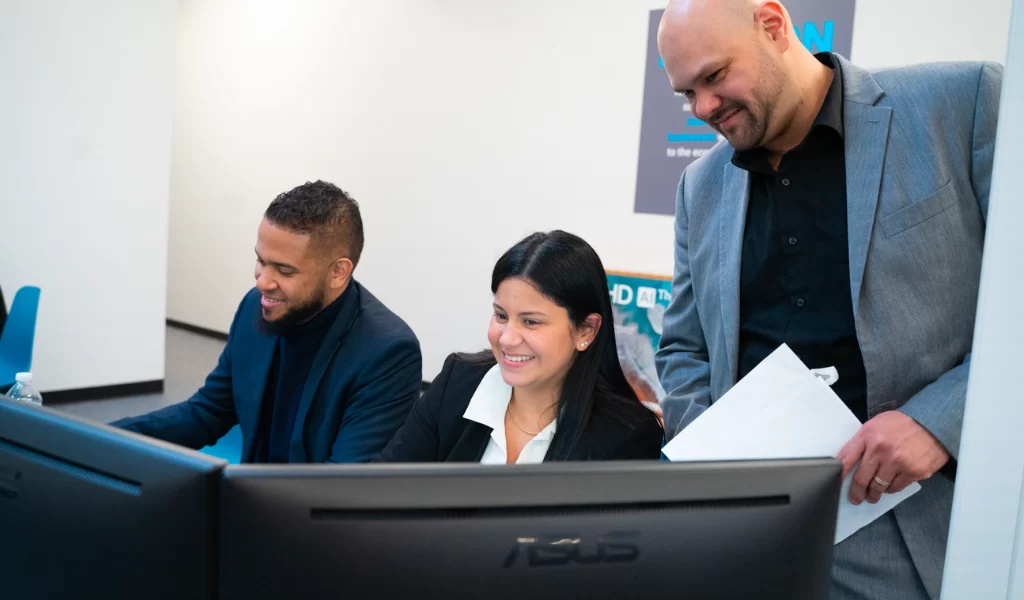 JBS employees working on dual monitors